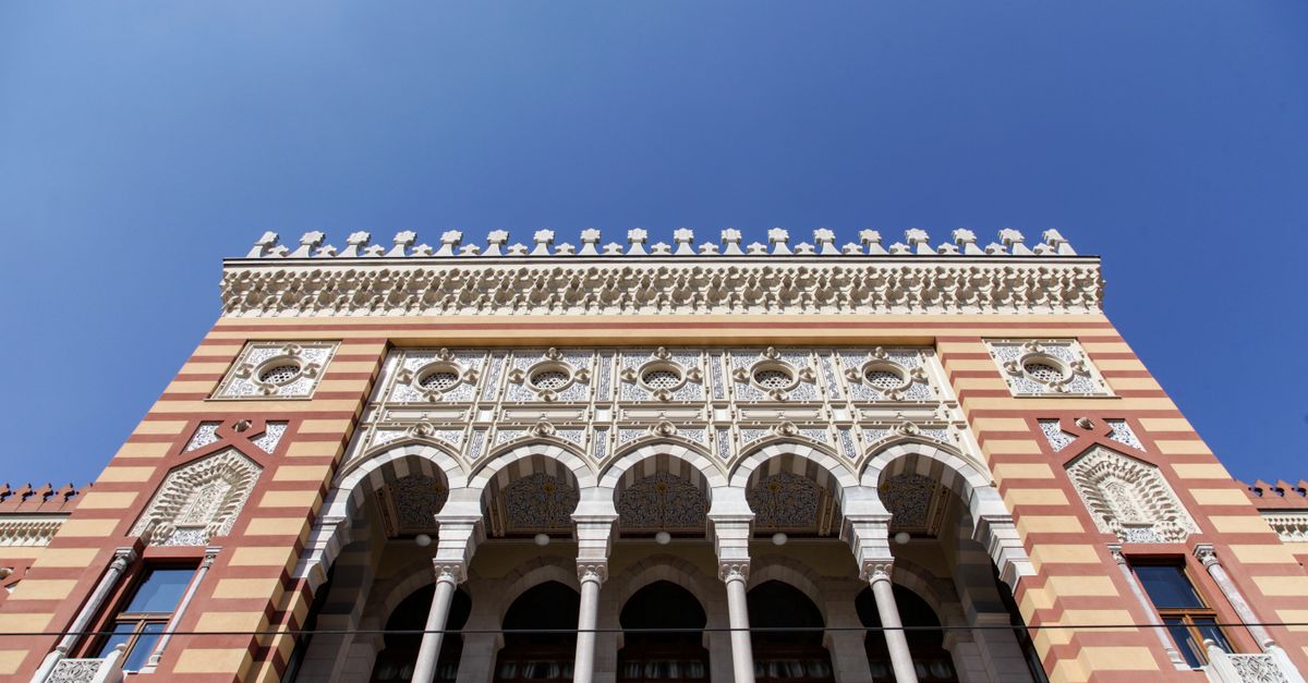 Ornate facade of Sarajevo City Hall showcasing historic architecture against a clear blue sky.