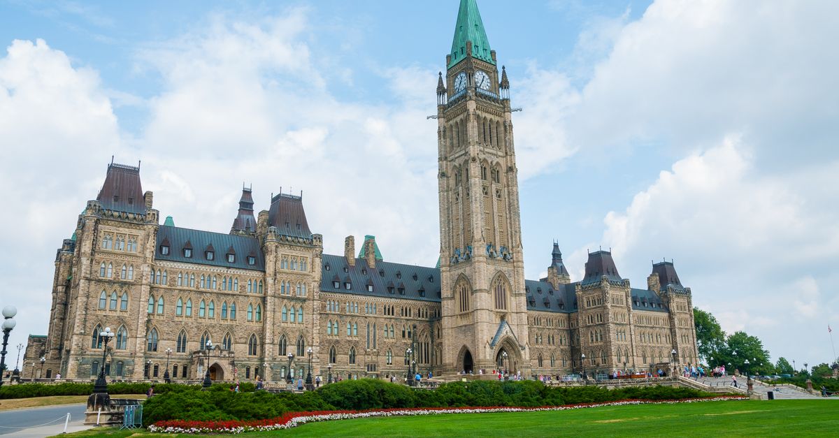 Stunning photo of Canada's Parliament Hill in Ottawa under a clear sky, showcasing Gothic Revival architecture.