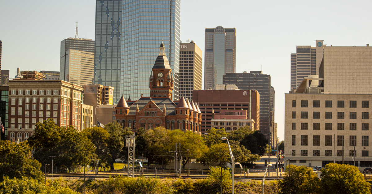 Scenic view of Dallas skyline featuring the Old Red Museum and skyscrapers.