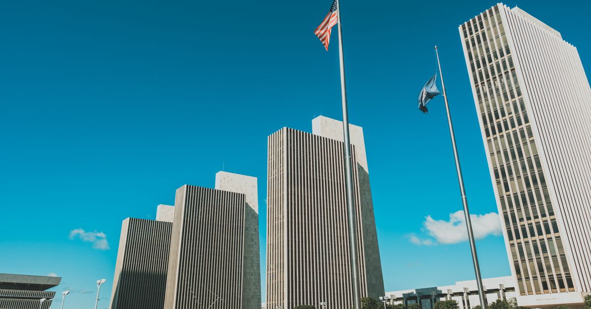 Modern skyscrapers towering at Empire State Plaza in Albany, New York under a clear blue sky.