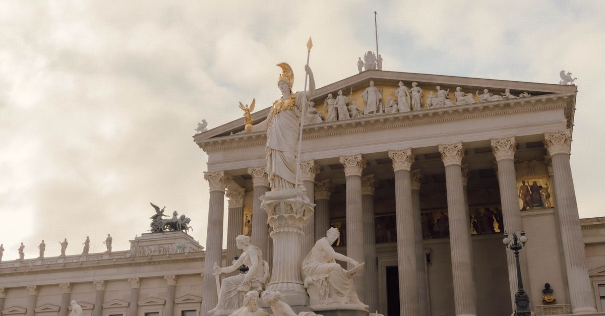 View of the Pallas Athene Fountain and Parliament Building in Vienna, Austria.