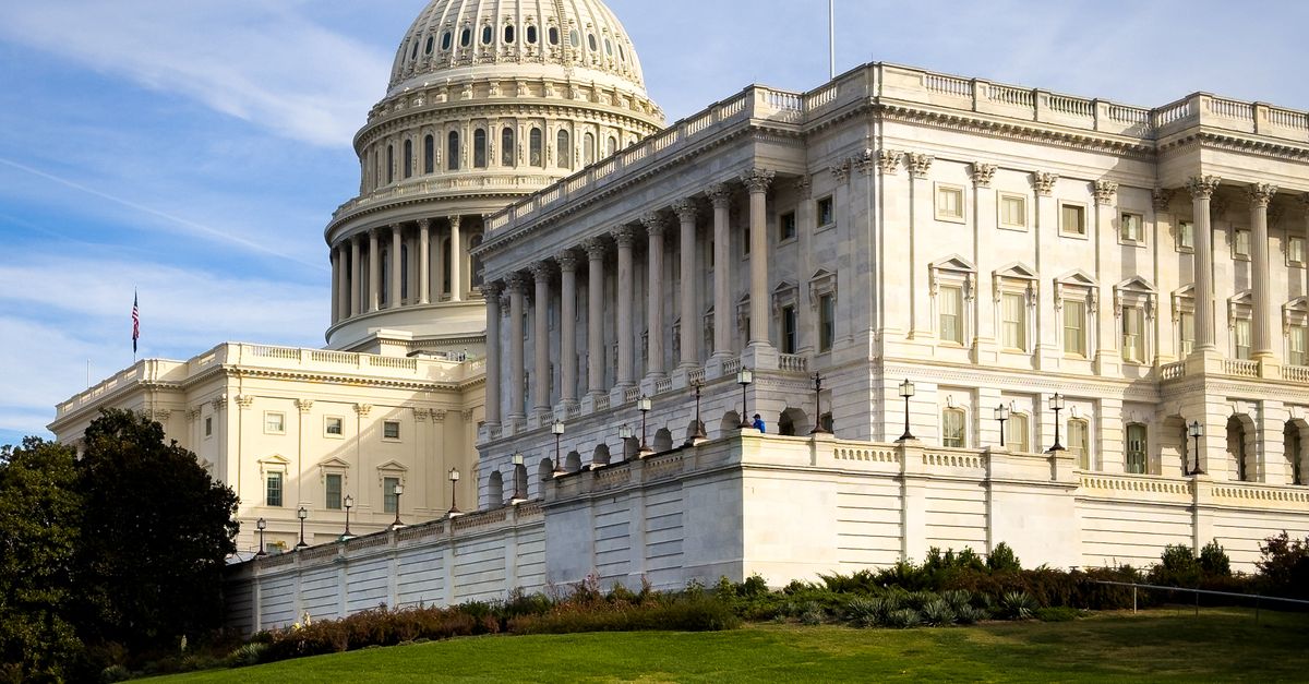 A picturesque view of the US Capitol Building in Washington, DC, under a clear sky.